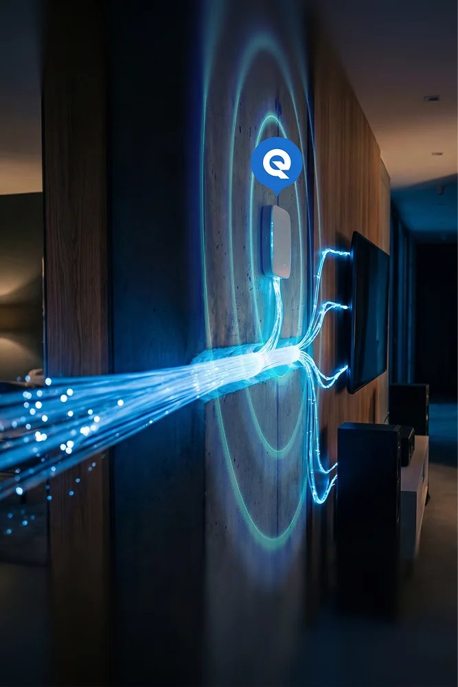 Wall-mounted access point with glowing blue fiber optic strands feeding into it and signal rings spreading on a wood wall